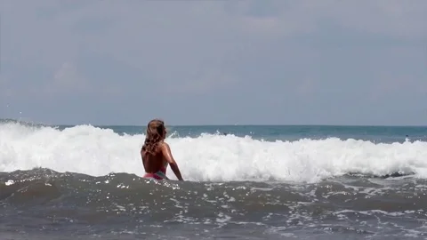 Female surfer going out to catch a wave in Bali Stock-Footage 71532604