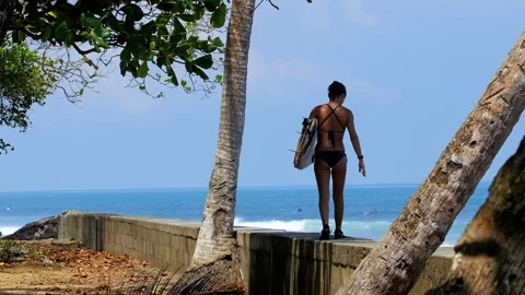 Female surfer ready for a session in Pavones, Costa Rica Stock Footage 336874664