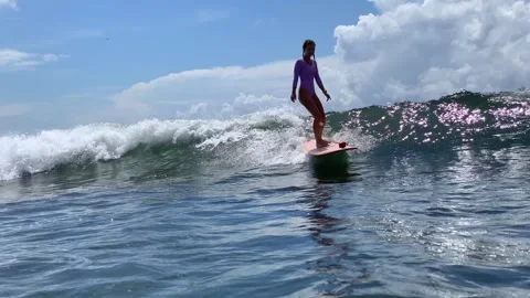 Female Surfer Skillfully Balancing On Small Water Waves Capturing Joy 스톡 동영상 329279031