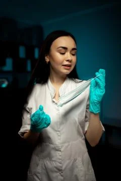 Female surgeon posing while removing face mask 스톡 사진