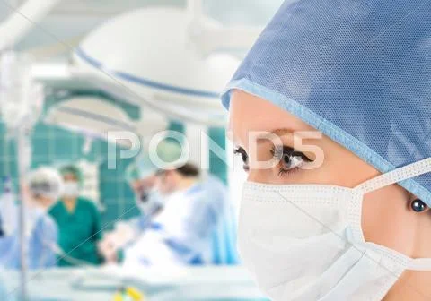Female surgeon with surgical team Stock Photos