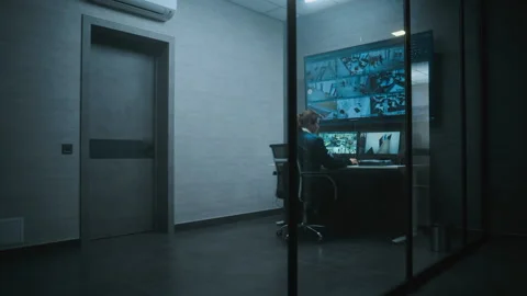 Female surveillance operator controls security cameras in monitoring center Stock Footage 281717417