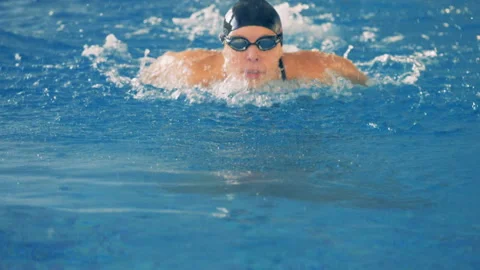 A female swimmer gets closer to the camera. Stock Footage