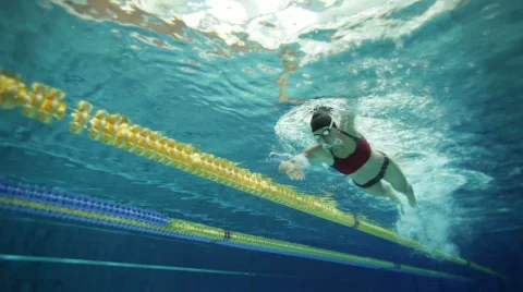 Female swimmer in indoor swimming pool Stock Footage