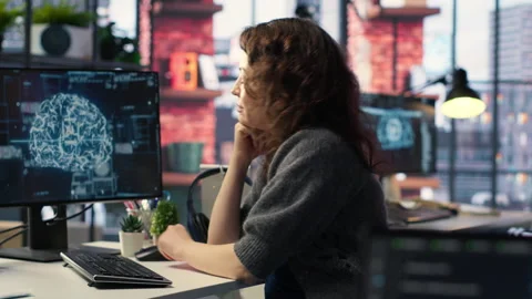 Female system admin doing maintenance on AI brain pc systems Stock Footage 308605056