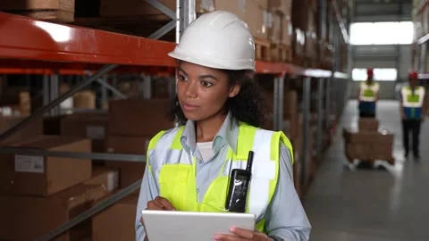 Female with tablet taking inventory in warehouse Stock Footage 161946960