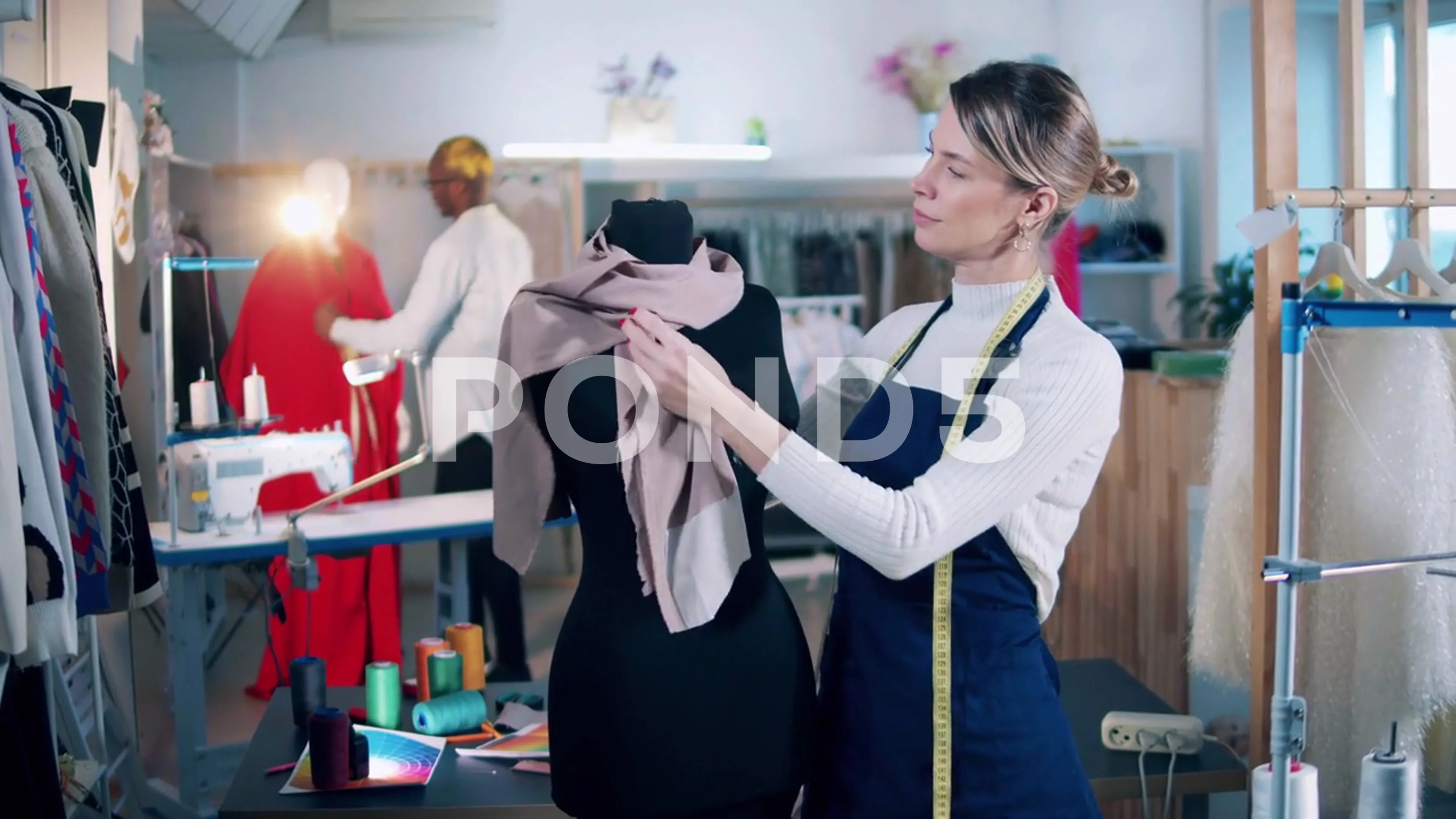 beautiful tailor women smiling when measure the mannequin chest