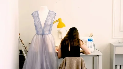 Female tailor working in her studio with sewing machine 動画素材 127484117