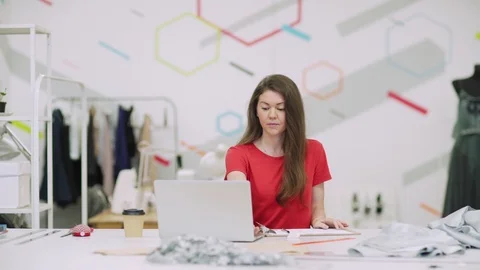 Female tailor working in studio Stock Footage 114498293