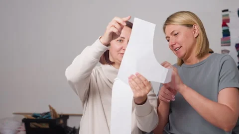 Female Tailors Reviewing Design Pattern And Smiling Indoors Stock Footage 307136132
