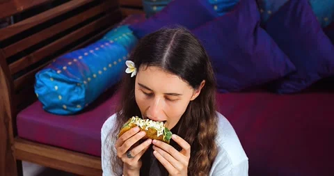 A Female Takes a Bite of a Crispy Corn Taco in Cafe Setting. Stock Footage 286433294