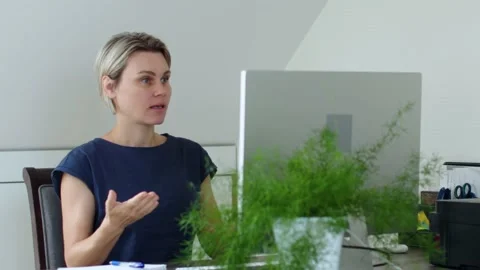 Female talking web camera desk computer monitor video call gesturing speaking Stock Footage 239950182