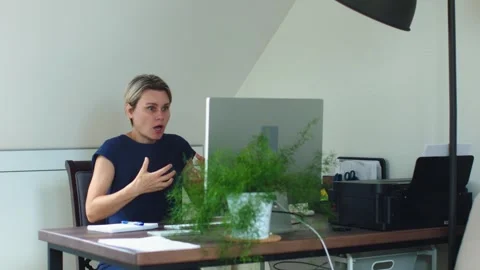 Female talking web camera desk computer monitor video call gesturing speaking Video stock 244174753