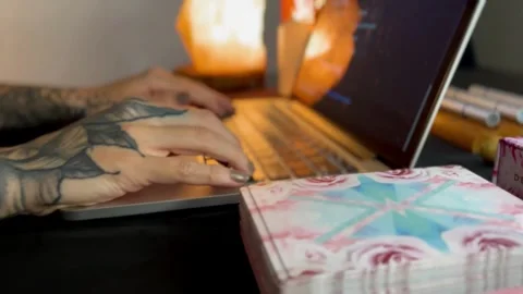 Female tattooed hand typing on computer keyboard / macbook Stock Footage 249837395