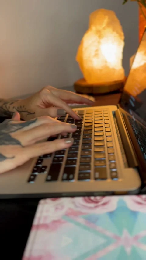 Female tattooed hand typing on computer keyboard Stock Footage 249837397