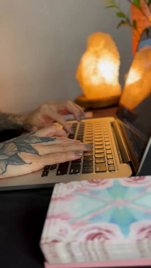 Female tattooed hand typing on computer keyboard Stock Footage 249837398
