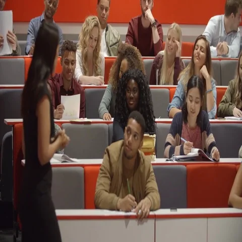 Female teacher and students in university lecture theatre Stock Footage