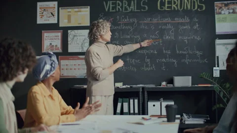 Female Teacher Explaining Gerund Form of Verb to Students in English Class Stock Footage 295830945