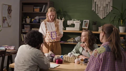 Female Teacher Explaining Knitting Pattern to Creative Class Stock Footage 341955801