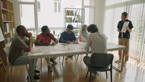 Female Teacher Explaining Lesson to Diverse Immigrant Students Stock Footage 240097010