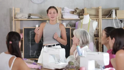Female teacher explaining pattern making during sewing course for adults Stock Footage 316582747