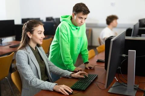 Female teacher explaining task solution to young boy 스톡 사진