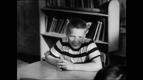 Female Teacher Interacting With Schoolboy In Elementary School Classroom Stock Footage 157788331