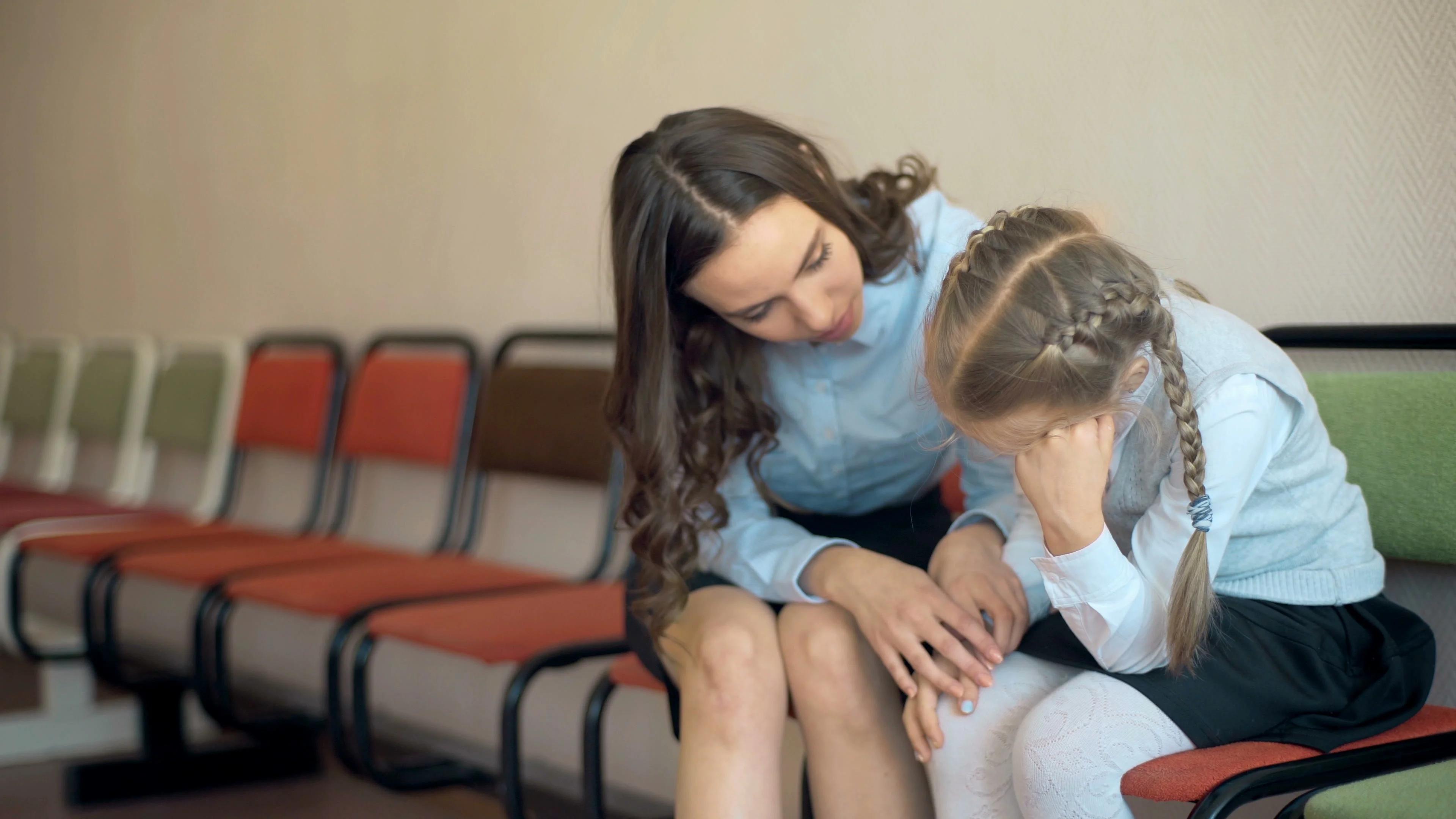 3840px x 2160px - A female teacher sits consoling a young ... | Stock Video | Pond5