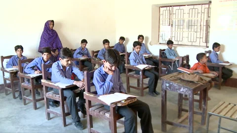 Female teacher teaching in a classroom Stock Footage 202215089
