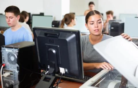 Female teacher uses a scanner in computer lab at school Stock Photos