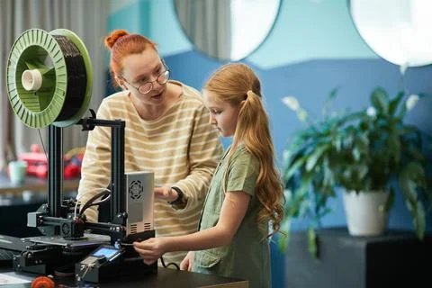 Female Teacher using 3D Printer with Girl in Engineering Class Stock Photos