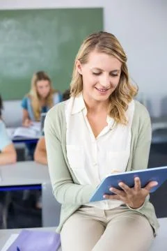 Female teacher using digital tablet in class 스톡 사진