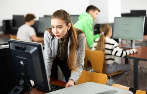 Female teacher working on computer in class Stock Photos