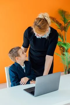Female teaching kids to work on computer 스톡 사진