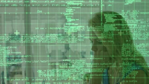 Female tech analyst receiving phone call, starting green code grid overlay Stock Footage 331833332