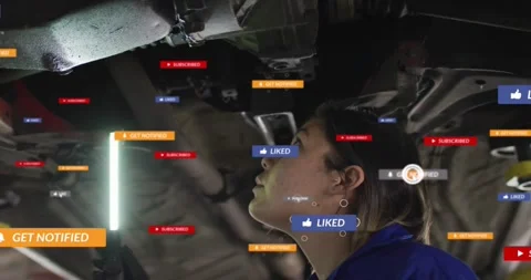 Female tech checking car underside with LED, cursor hovering causing LIKE badges Stock Footage 334038971