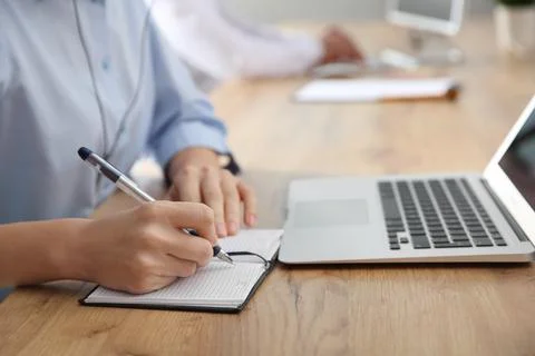 Female technical support operator at workplace, closeup on hands Stock Photos