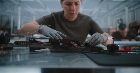 Female Technician Assembling Quadcopter in Drone Manufacturing Plant Stock-Footage 345063316