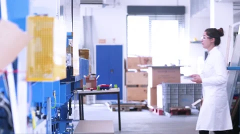 Female technician checking on mechanical equipment with a tablet. Stock Footage 57989948