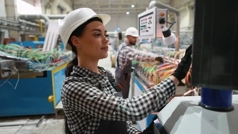 Female technician operating CNC machine in modern industrial factory 스톡 동영상 314584028