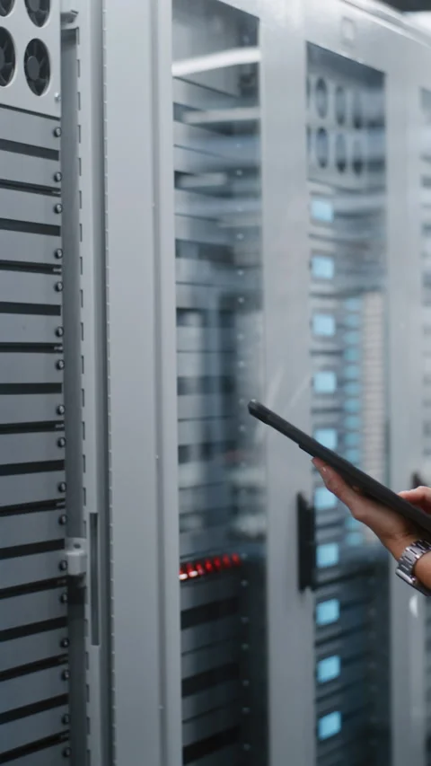 Female Technician Operating Server Cabinet Controls While Checking Tablet Data Stock Footage 344954659