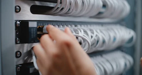 Female Technician Servicing Network Switch Ports in Enterprise Data Center Stock Footage 344970484