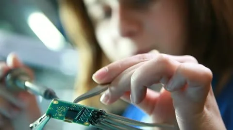 Female technician solders circuit board Stock Footage
