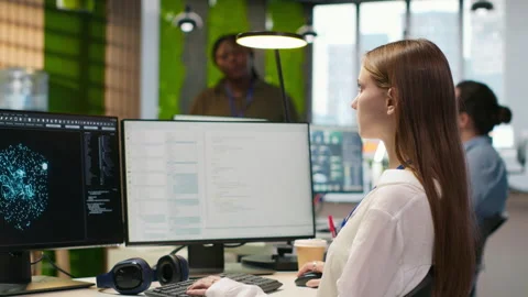 Female technician testing generative AI machine learning algorithms at work Stockbeeldmateriaal 313016646