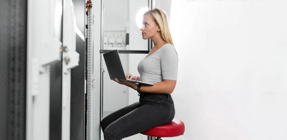  Female technician using laptop in server room Portrait of technician work... Stock-Fotos