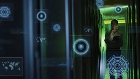 Female technician walking server aisle tapping tablet, generating 3D charts and Stock Footage 332577572