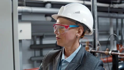 Female technician working and checking machine in a large industrial factory Video stock 143564815