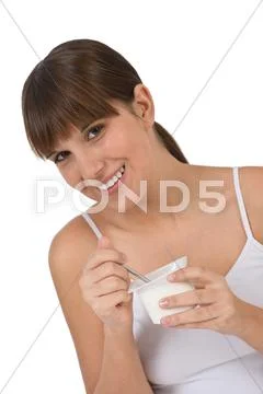 Female teenager eat healthy yogurt for breakfast Stock Photos