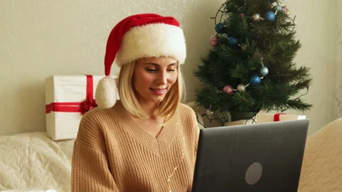Female texting, smiling, dancing, sitting on sofa in decorated living room. Stock Footage 164591869
