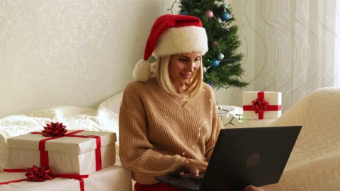 Female texting, smiling, dancing, sitting on sofa in decorated living room. Stock Footage 164595293